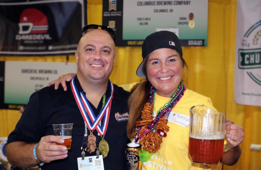 Tony Corder is congratulated by a volunteer pourer for the pair of Columbus Brewing Co. medals